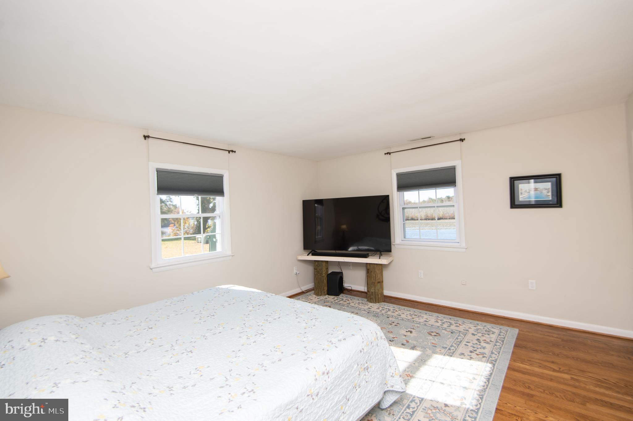 25211 Adams Landing Road Denton, MD 21629 - Photo 53 of 58 a bedroom with a bed and a flat screen tv