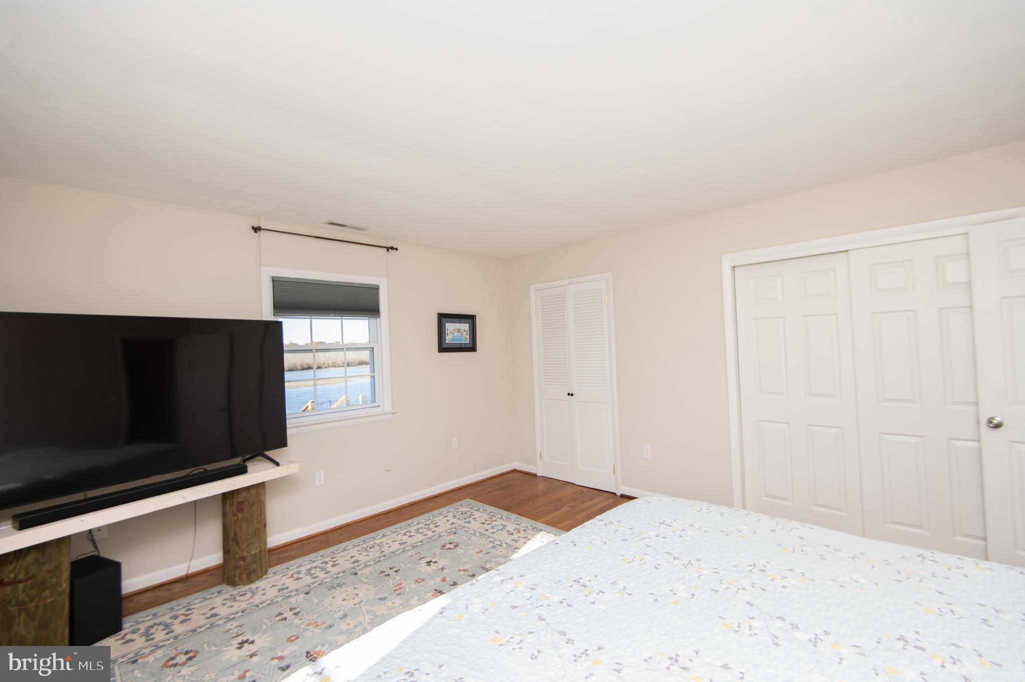 25211 Adams Landing Road Denton, MD 21629 - Photo 54 of 58 a bedroom with a bed and a flat screen tv