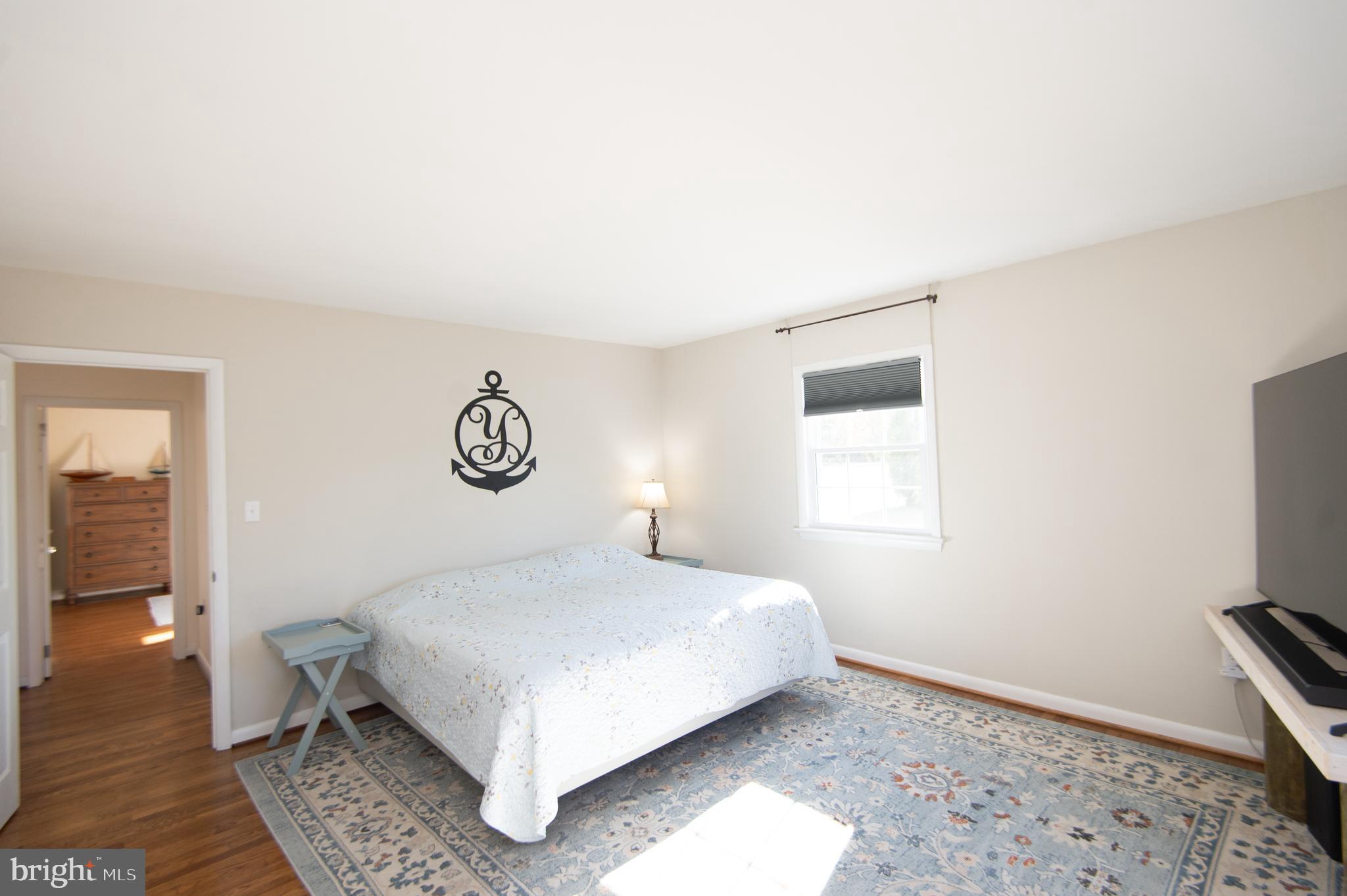 25211 Adams Landing Road Denton, MD 21629 - Photo 55 of 58 a bedroom with a bed and wooden floor