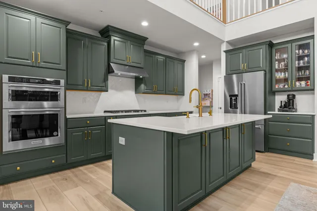 a kitchen with kitchen island granite countertop stainless steel appliances and cabinets