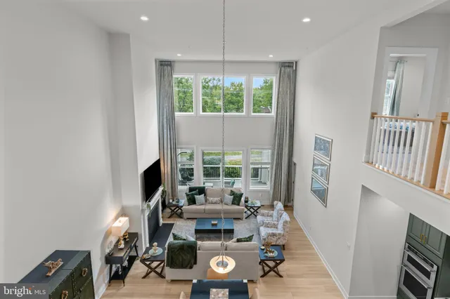a view of a livingroom with furniture wooden floor and a window