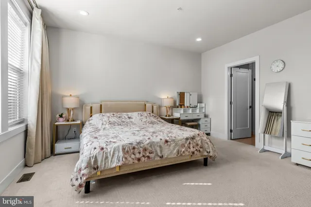 a bedroom with a bed and a lamp