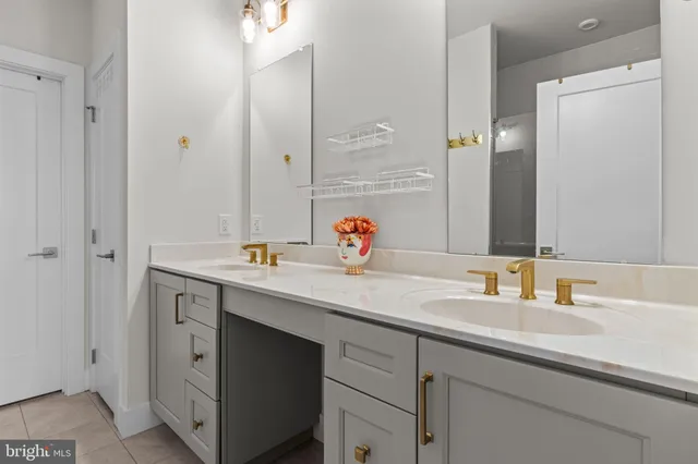 a bathroom with a sink double vanity granite and a mirror