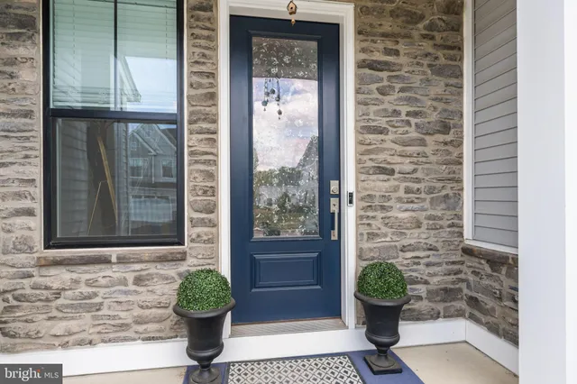 a front view of a house with a potted plant