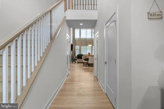 a view of a hallway with a livingroom and entryway