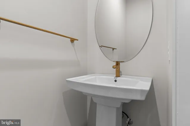 a bathroom with a sink a mirror and vanity