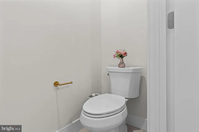 a white toilet sitting next to a white sink