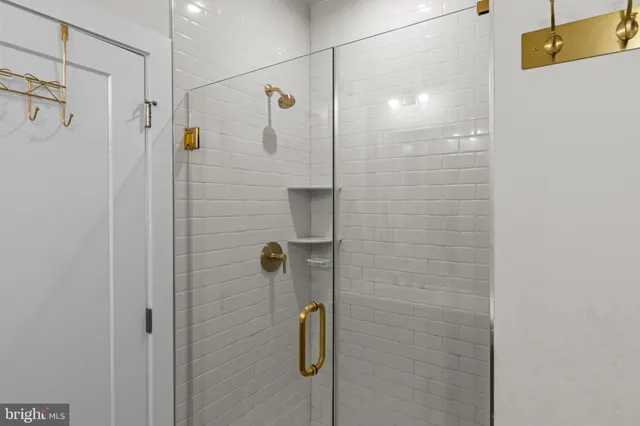 a bathroom with a shower and a glass door shower