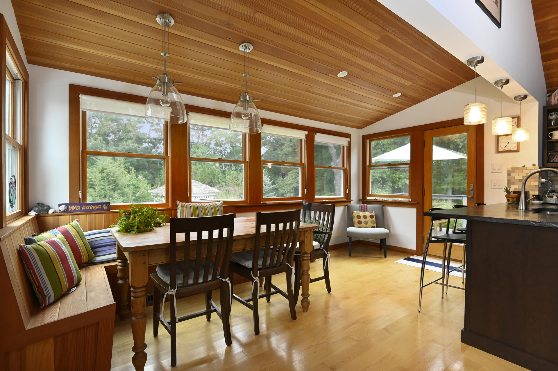 15 Clayton Road Eastham, MA 02642 - Photo 13 of 49 a view of a dining room with furniture large windows and wooden floor