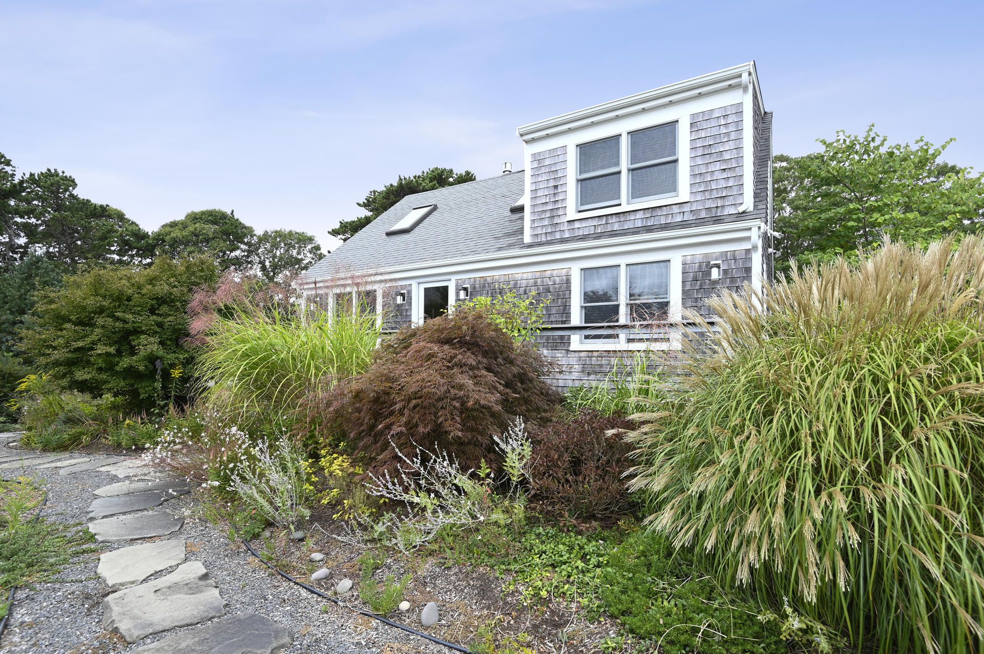 15 Clayton Road Eastham, MA 02642 - Photo 3 of 49 a front view of a house with a yard