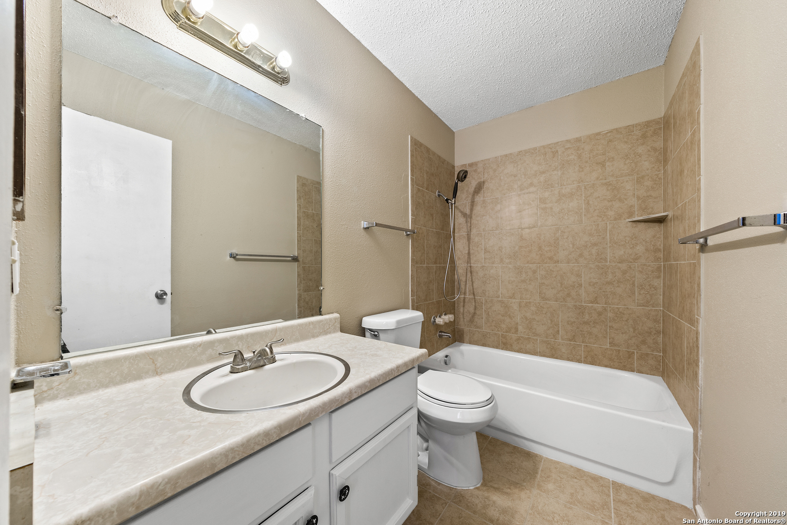 109 Meadow Way Converse, TX 78109 - Photo 15 of 25 a bathroom with a granite countertop sink a toilet a mirror a bathtub and shower