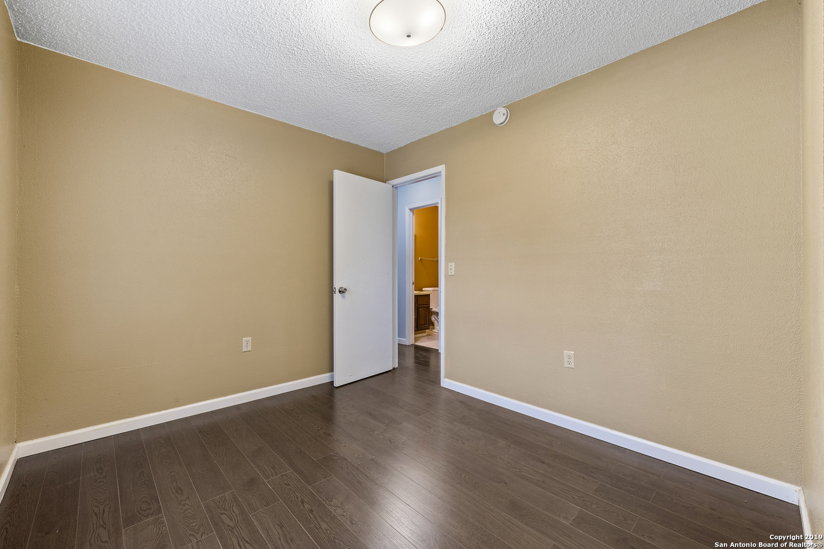 109 Meadow Way Converse, TX 78109 - Photo 18 of 25 a view of an empty room with wooden floor
