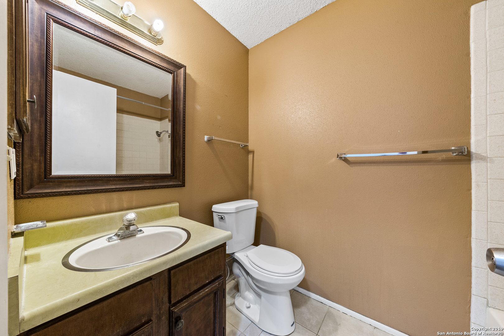 109 Meadow Way Converse, TX 78109 - Photo 22 of 25 a bathroom with a sink and a mirror