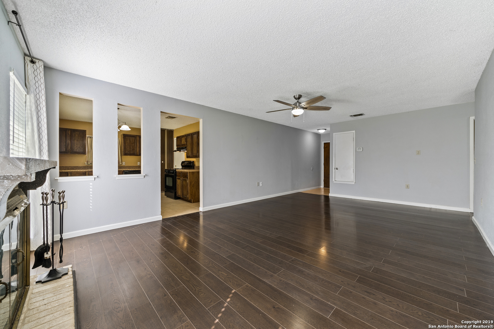 109 Meadow Way Converse, TX 78109 - Photo 8 of 25 wooden floor in an empty room with a window