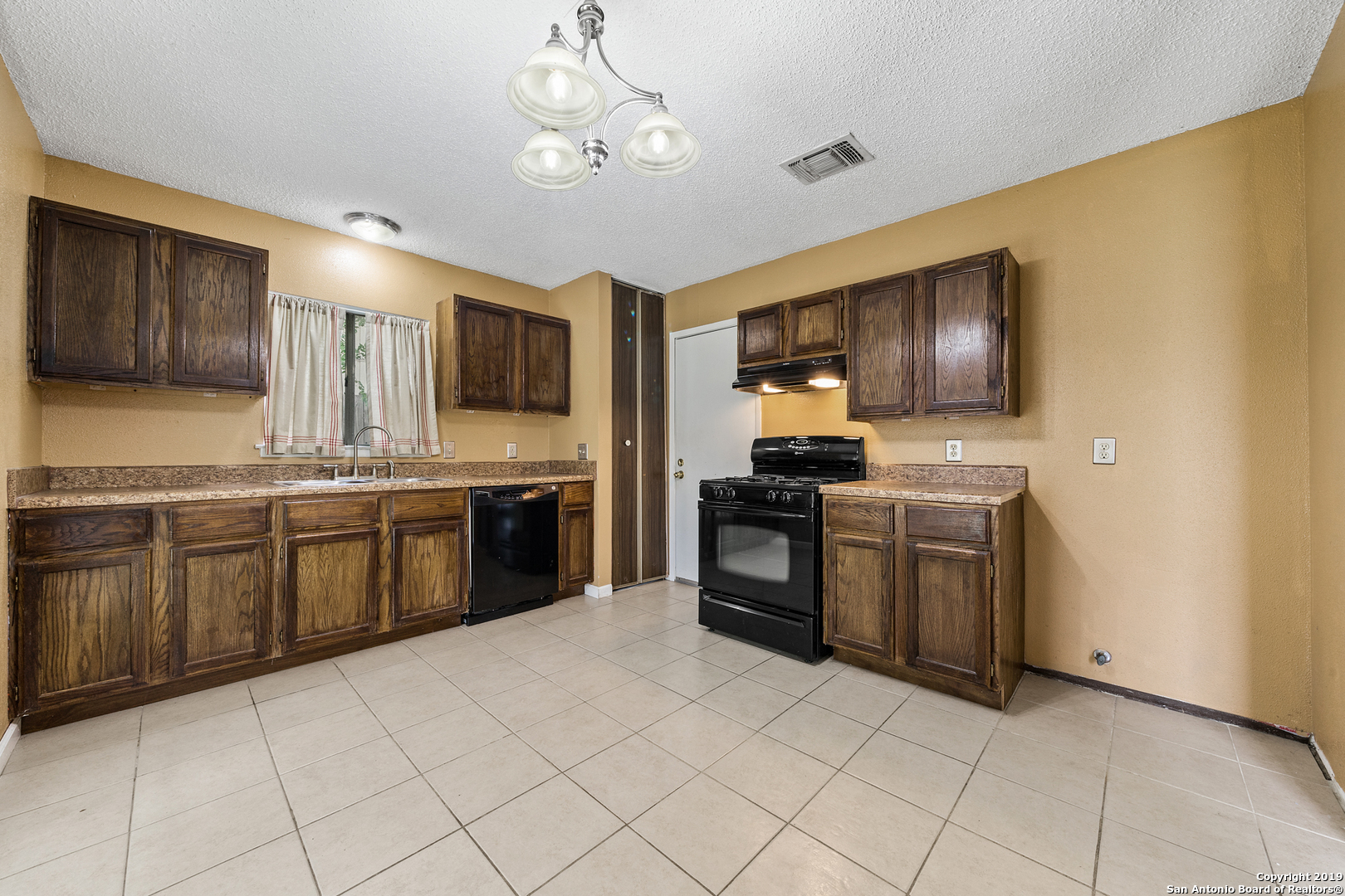 109 Meadow Way Converse, TX 78109 - Photo 10 of 25 a kitchen with stainless steel appliances granite countertop a stove cabinets and refrigerator