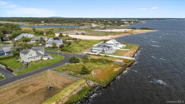 an aerial view of residential houses with outdoor space and lake view