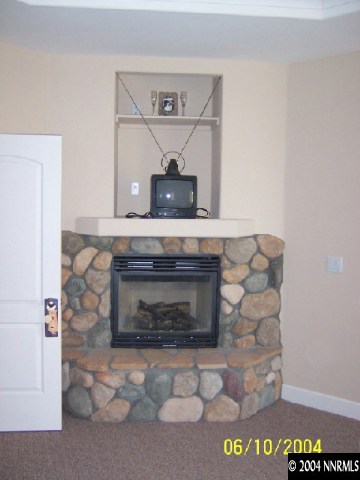 1701 Sheckler Road Fallon, NV 89406 - Photo 3 of 9 a living room with a stove and a fireplace