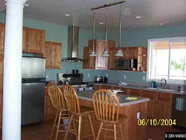1701 Sheckler Road Fallon, NV 89406 - Photo 4 of 9 a kitchen with stainless steel appliances granite countertop a sink a stove and a refrigerator