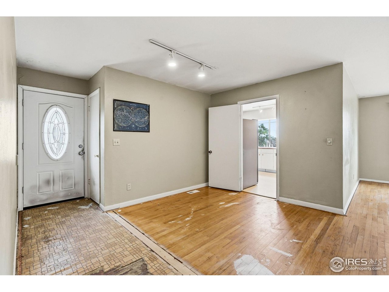 4595 Moorhead Avenue Boulder, CO 80305 - Photo 4 of 40 a view of an empty room with window and wooden floor