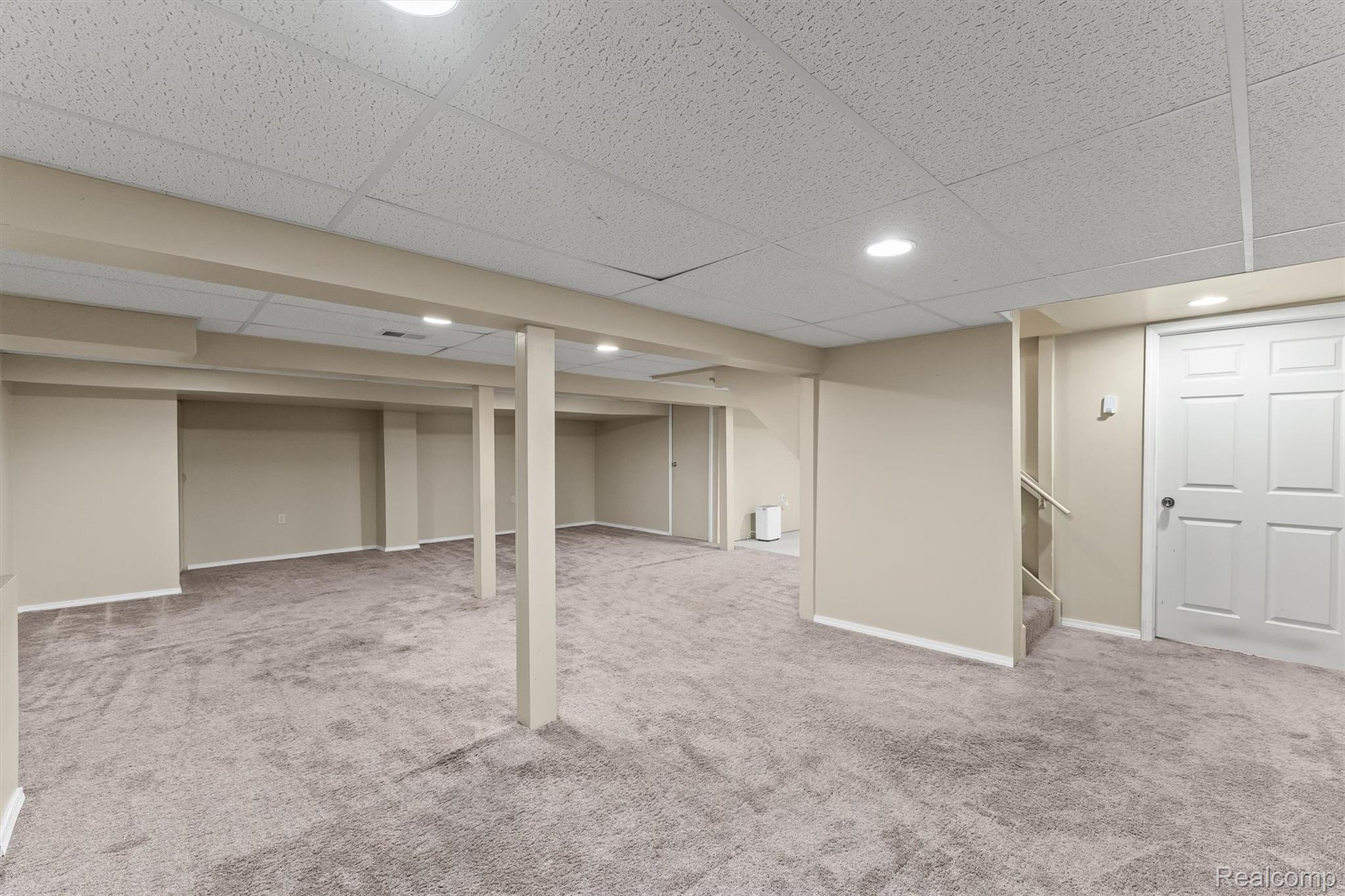 2118 Rutgers Drive Troy, MI 48085 - Photo 28 of 39 Expansive finished basement featuring recessed lighting, neutral wall tones, durable carpeting, and a drop ceiling
