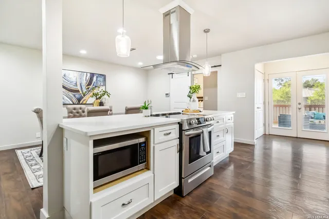 a kitchen with a stove oven and a sink