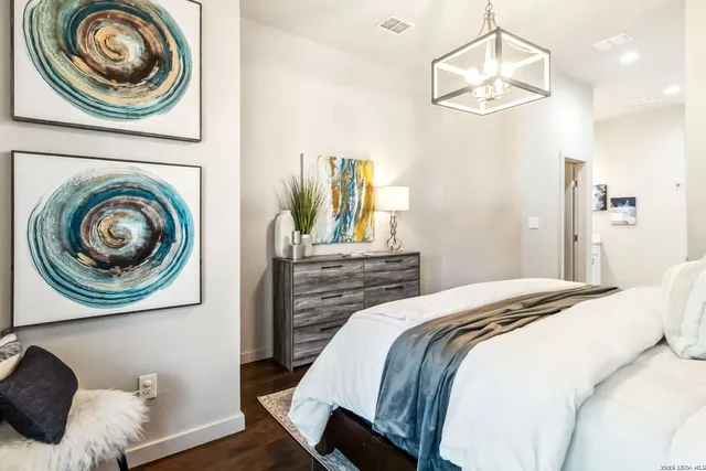 a bedroom with a bed and a chandelier