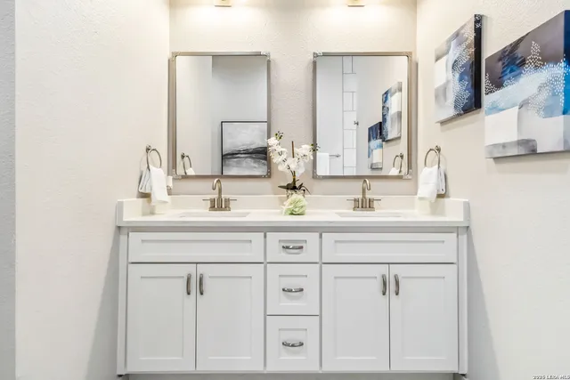 a bathroom with a sink vanity and a mirror