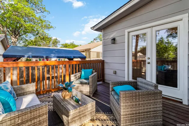 a backyard of a house with barbeque oven table and chairs