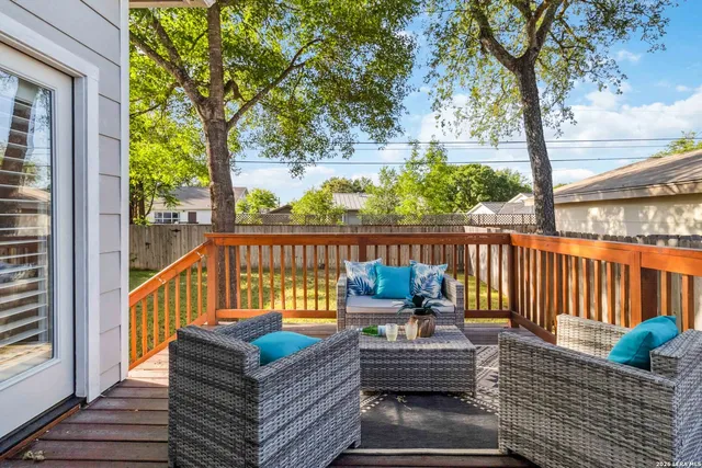 a balcony with wooden floor and furniture