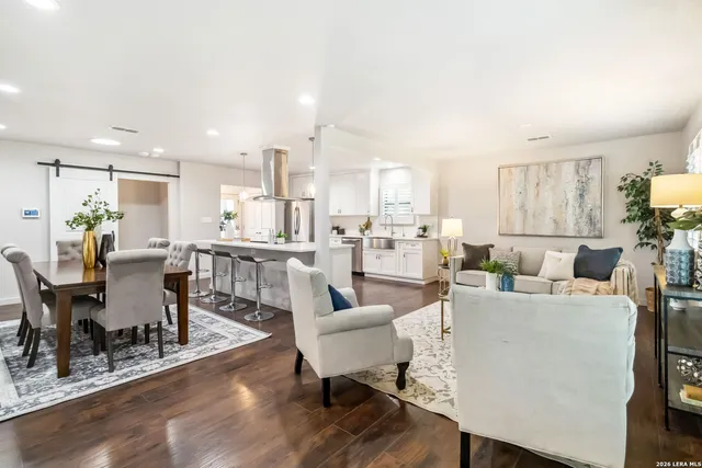 a living room with lots of furniture and kitchen view