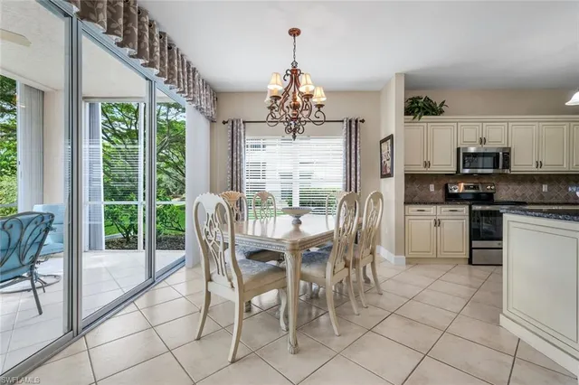 a view of a dining room with furniture large windows and wooden floor
