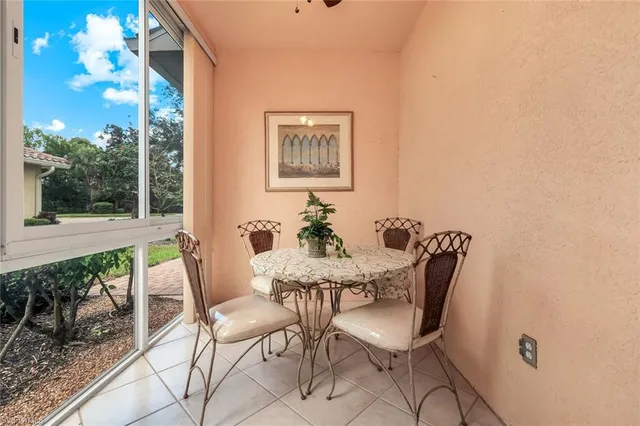 a view of a dining room with furniture wooden floor and a floor to ceiling window