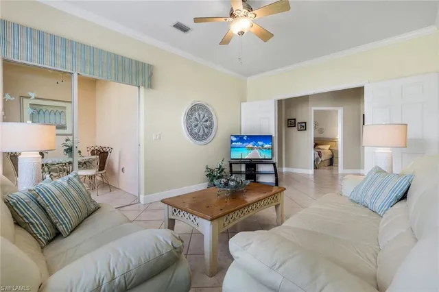 a living room with furniture and a lamp