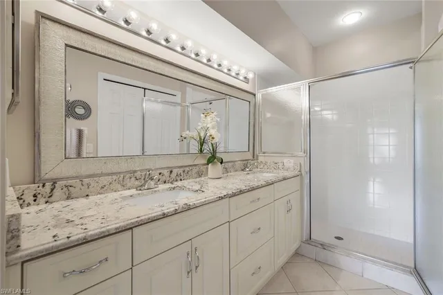 a bathroom with a granite countertop sink mirror and double