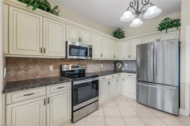 a kitchen with cabinets stainless steel appliances and a counter space
