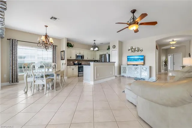 a large kitchen with cabinets and stainless steel appliances
