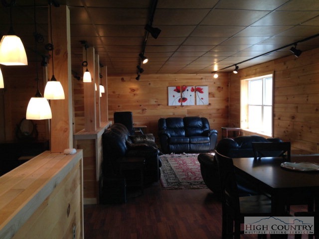 620 Green Knob Mountain Road Boone, NC 28607 - Photo 20 of 43 a living room with furniture a window and a chandelier