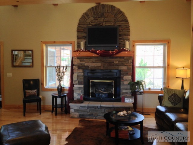 620 Green Knob Mountain Road Boone, NC 28607 - Photo 42 of 43 a living room with furniture a flat screen tv and a fireplace