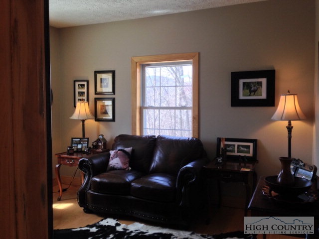 620 Green Knob Mountain Road Boone, NC 28607 - Photo 5 of 43 a living room with furniture and a lamp