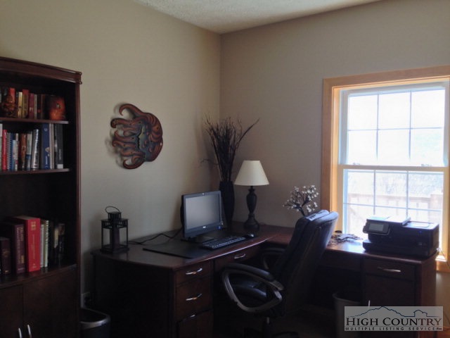 620 Green Knob Mountain Road Boone, NC 28607 - Photo 6 of 43 a living room with furniture a bookshelf and a window
