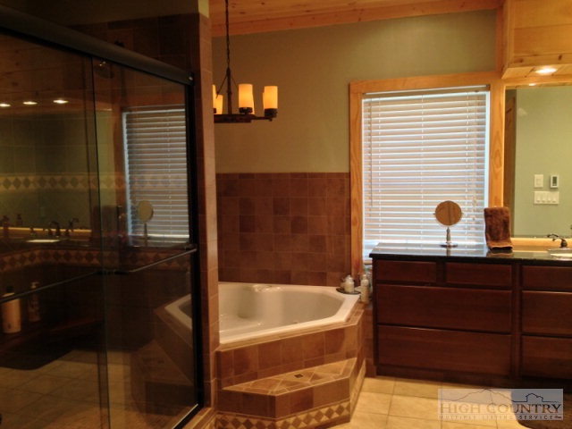 620 Green Knob Mountain Road Boone, NC 28607 - Photo 8 of 43 a bathroom with a bathtub and a sink