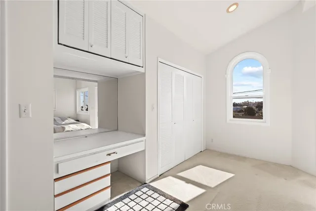a view of bathroom with a sink cabinet and a mirror