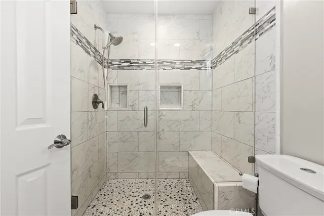 a bathroom with a shower a toilet and a shower
