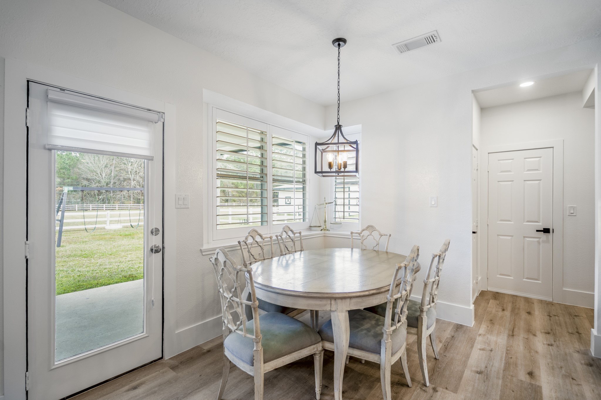 31219 Edgewater Drive Magnolia, TX 77354 - Photo 16 of 49 a view of a dining room with furniture window and wooden floor