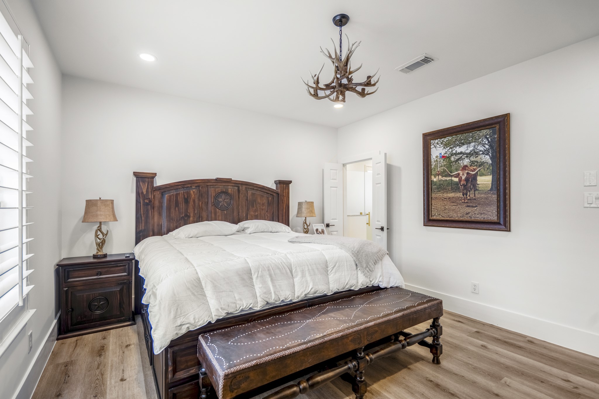 31219 Edgewater Drive Magnolia, TX 77354 - Photo 18 of 49 a bedroom with a bed and a chandelier