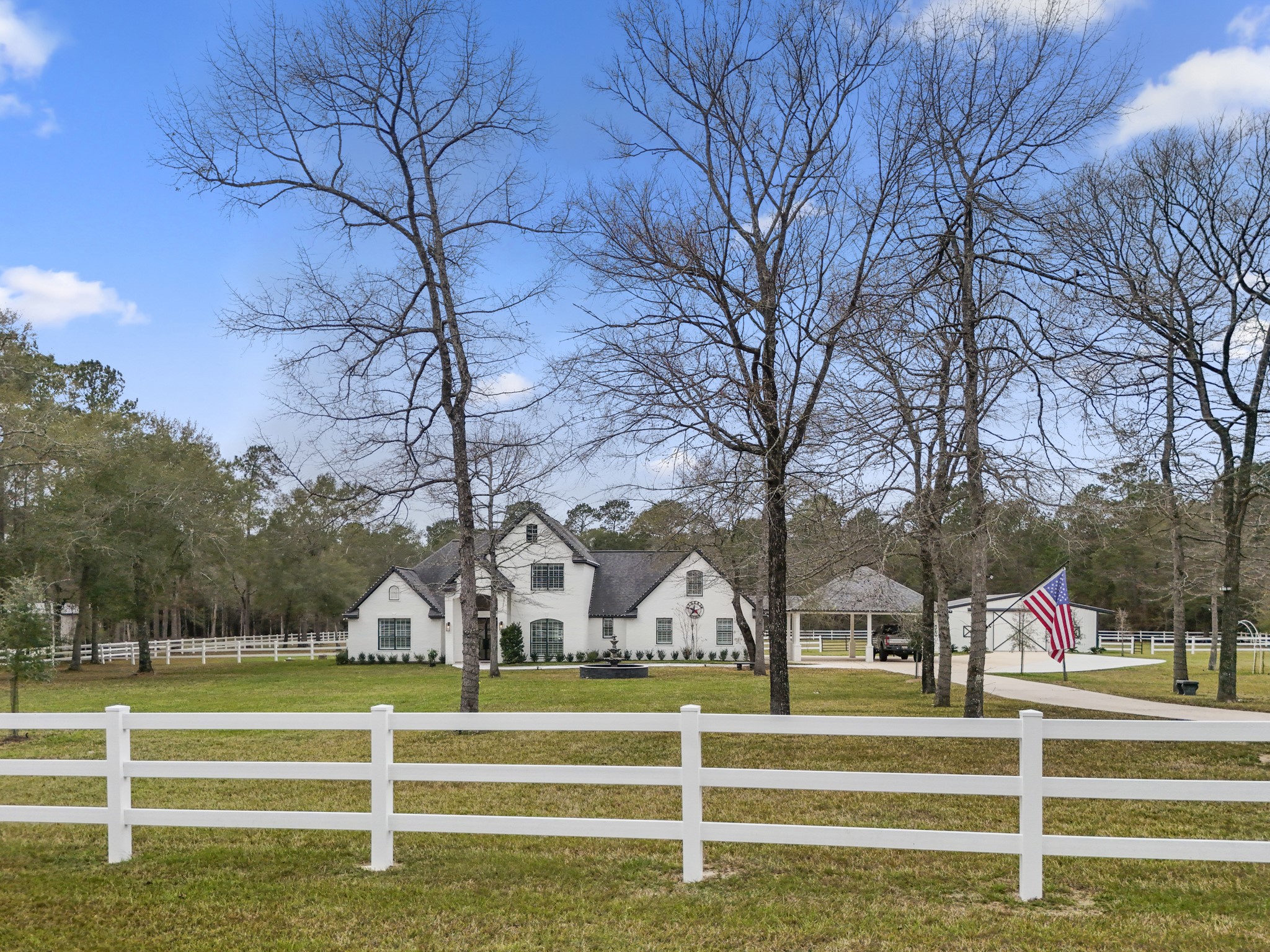 31219 Edgewater Drive Magnolia, TX 77354 - Photo 3 of 49 a view of large trees in front of a house