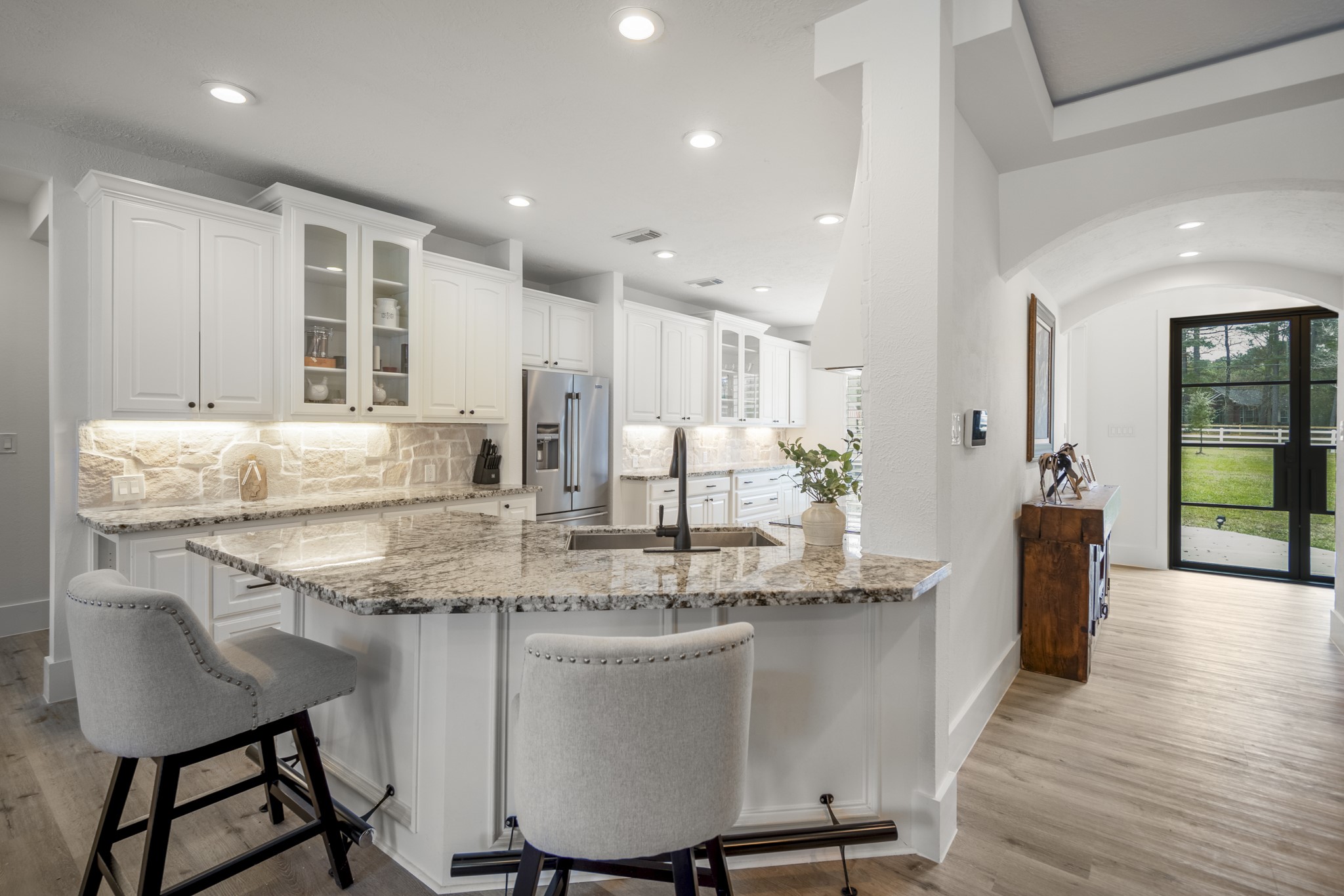 31219 Edgewater Drive Magnolia, TX 77354 - Photo 10 of 49 a kitchen with kitchen island granite countertop a table chairs sink and cabinets