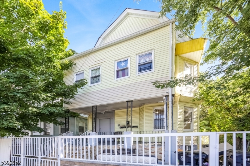904 South 18th Street Newark, NJ 07108 - Photo 14 of 16 a front view of a house with a garden