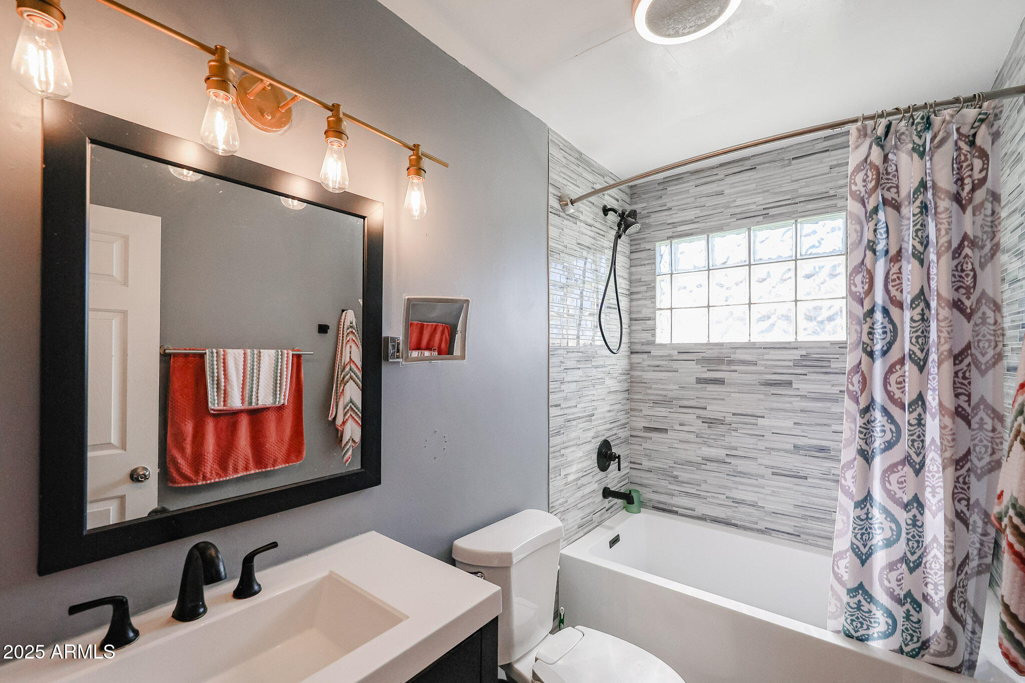 2037 West State Avenue Phoenix, AZ 85021 - Photo 11 of 18 a bathroom with a sink and a mirror