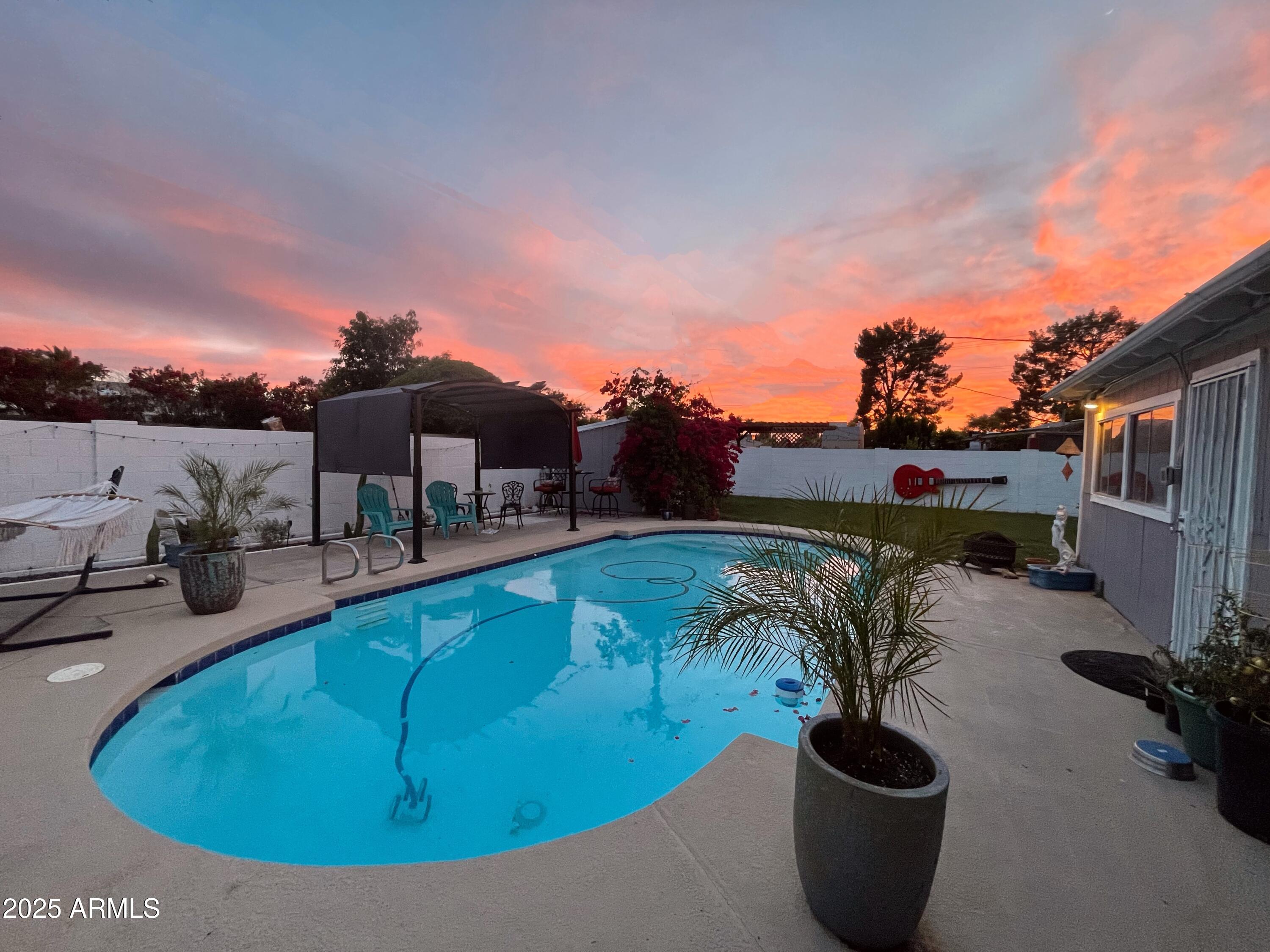 2037 West State Avenue Phoenix, AZ 85021 - Photo 18 of 18 a view of a swimming pool with a lounge chairs